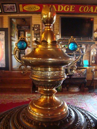 Round Oak 24'' Match Strike Heater with a Rare two blue Jeweled Finial. The jewels are reproduction. $3850