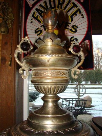18'' Matchstrike with three matchstrike windows with the option of three mica windows. Cast Iron top ring. All original condition. The finial is an all original red two jeweled finial. $3250.00