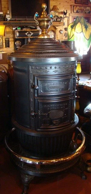 Round Oak 24'' Match Strike Heater with a Rare two blue Jeweled Finial. The jewels are reproduction. $3850