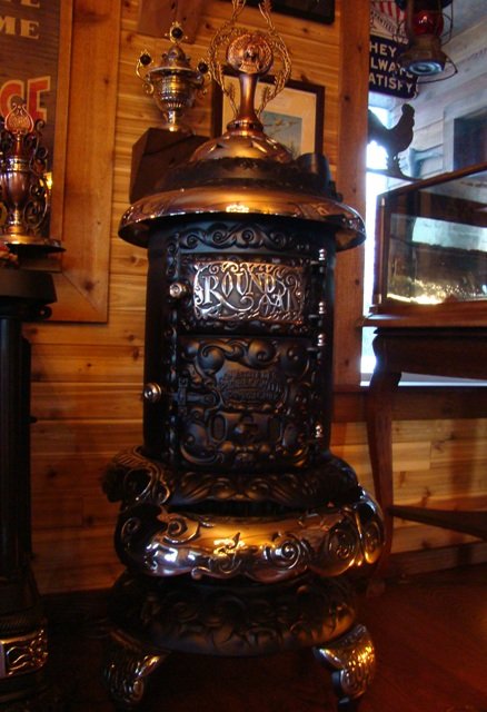 M-14 Round Oak Stove. Original small trademark finial. $2450.00