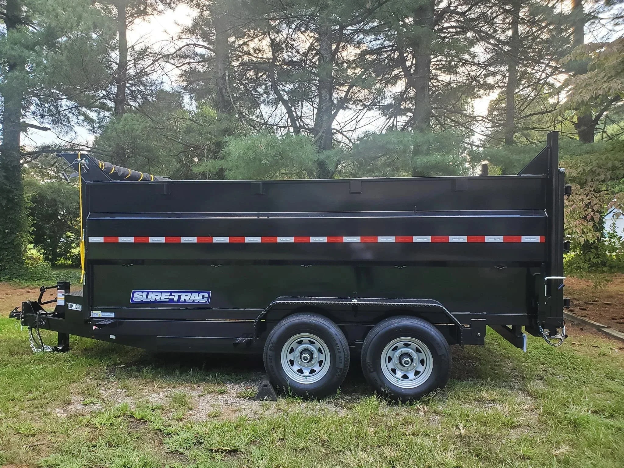side angle of black dumpster trailer