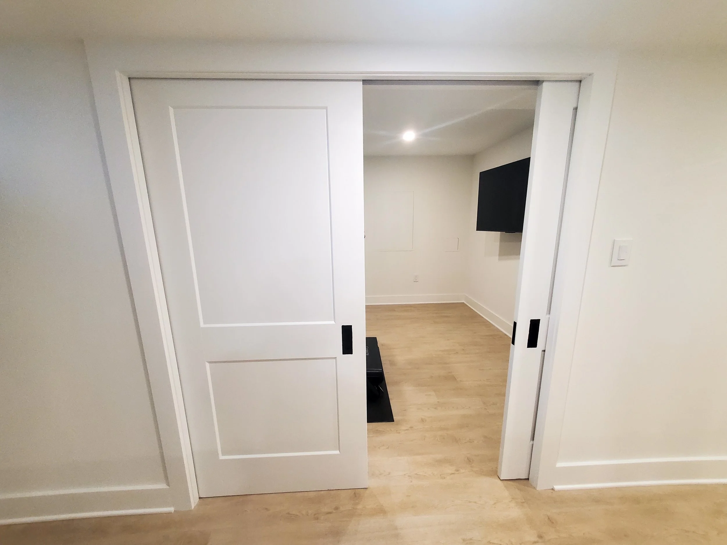 Custom pocket door with molding around doorframe