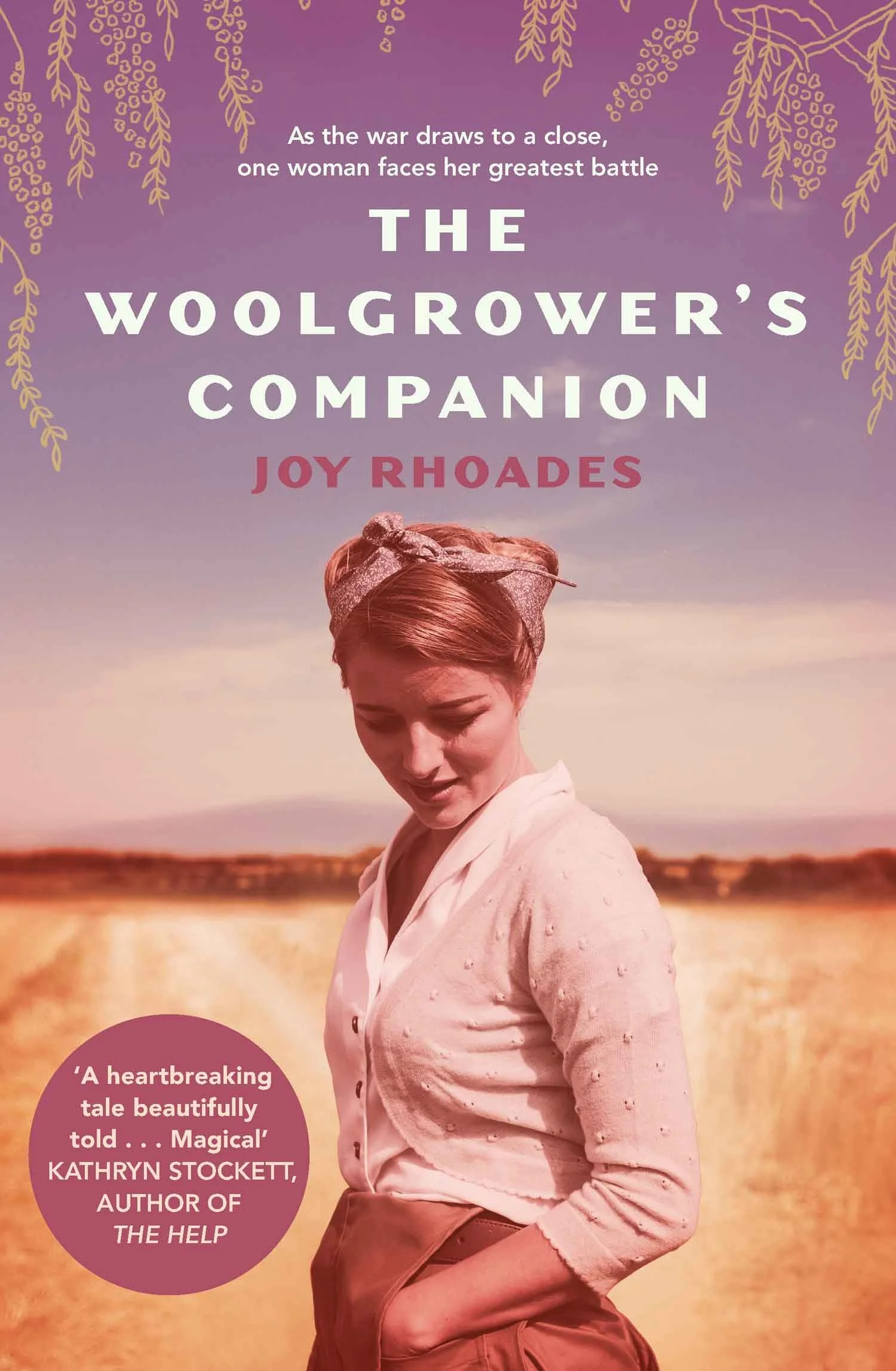 Cover of 'The Woolgrower's Companion' by Joy Rhoades featuring a woman in vintage attire against a rural landscape with the text "As the war draws to a close, one woman faces her greatest battle."
