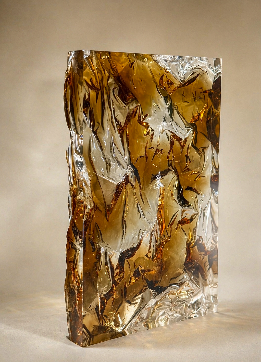 Translucent cast resin panel in warm amber, smoke, and gold tones with subtle metallic reflections, featuring a textured back that refracts light and creates a glowing, layered effect.