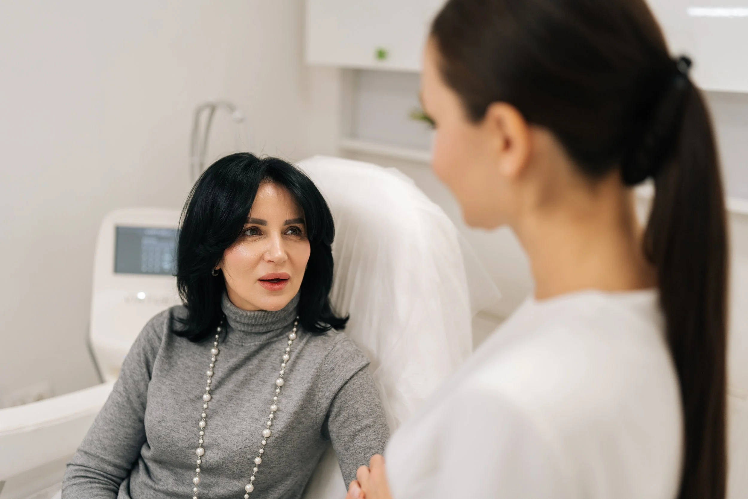 Woman discussing Ultherapy and non-surgical skin tightening options with a provider in Acworth.