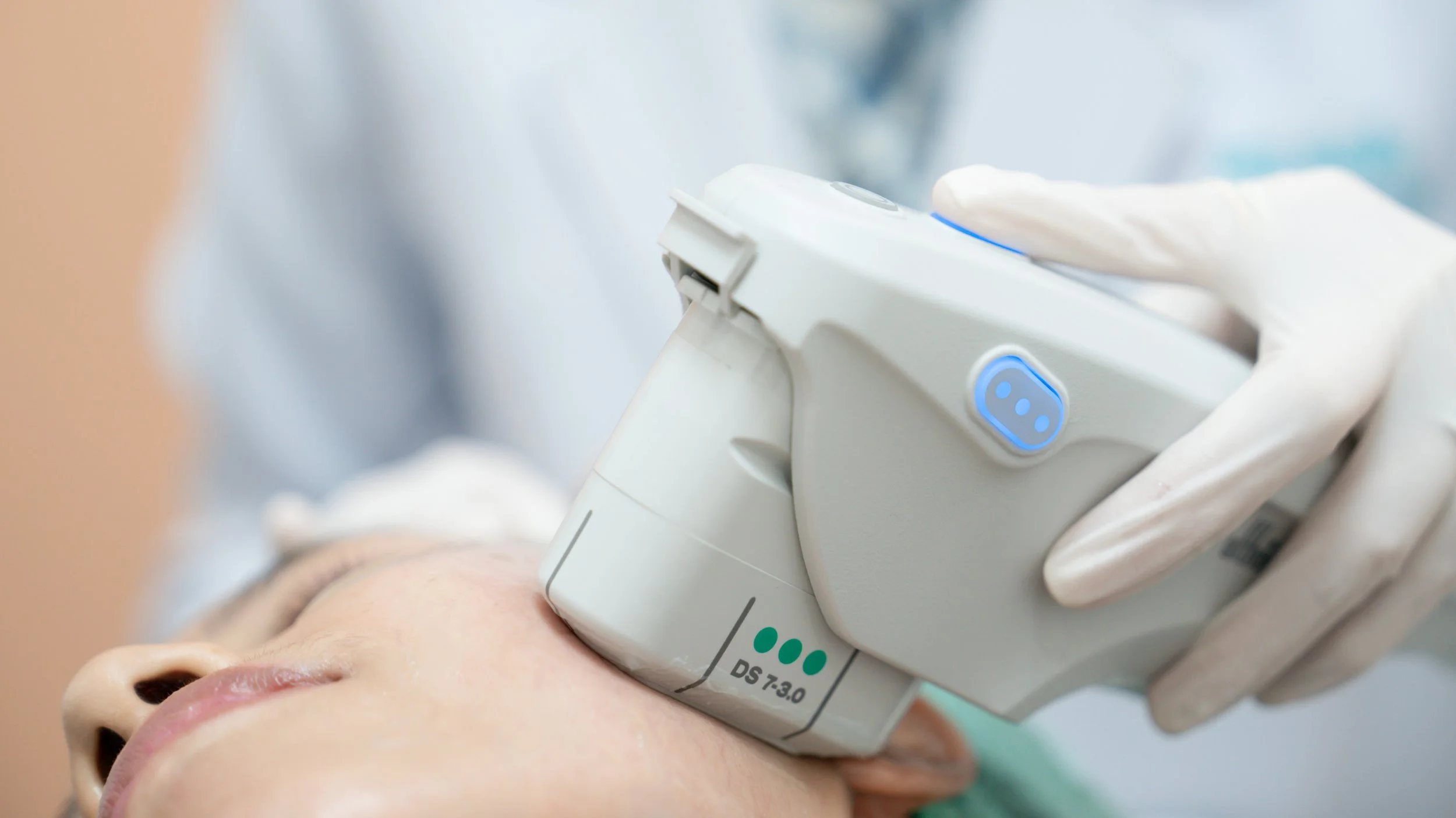 Provider performing an Ultherapy non-surgical skin tightening treatment on a patient’s face.