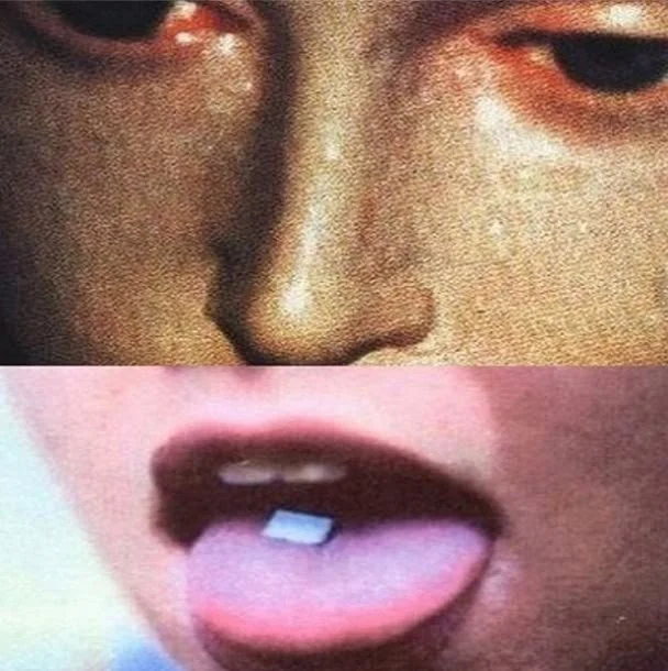 Close-up of a person's face with one eye partly closed and showing a gap between front teeth with tongue slightly out and lsd tablet.