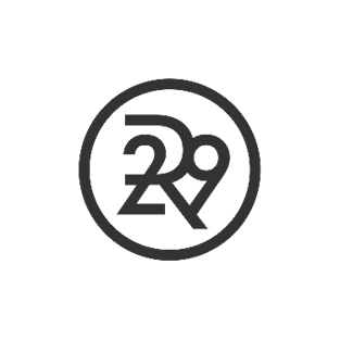 dark grey circle outline with the interlocking logo of an R, 2, and 9 in the center, representing Refinery 29.