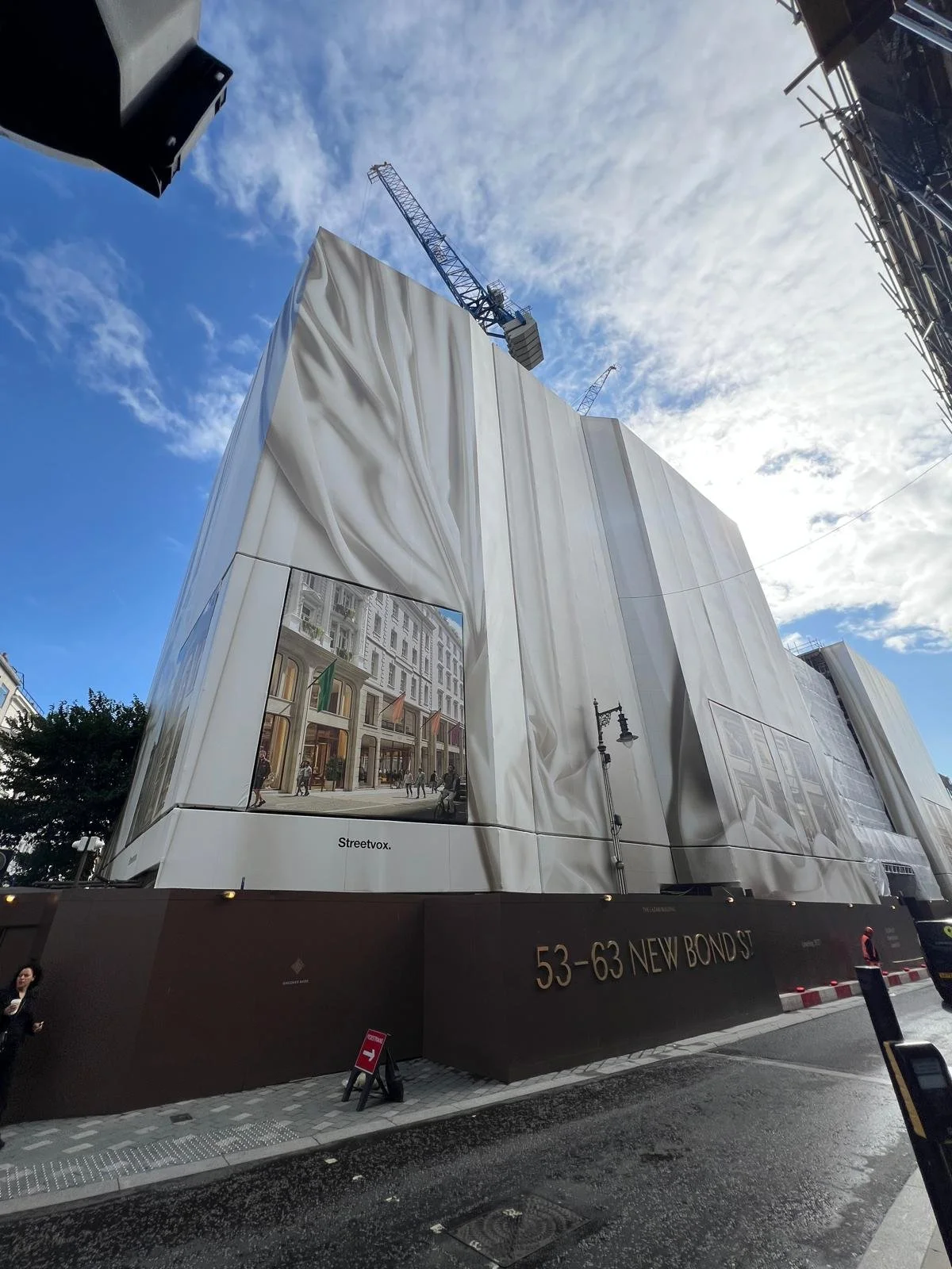 This printed hoarding wrap reveals what the former historic Fenwick department store will soon become.