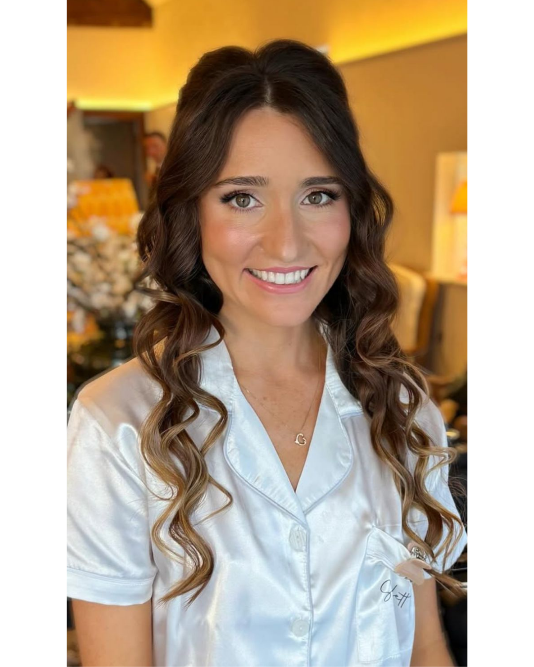 A bride wearing her hair down with waves and soft glam makeup