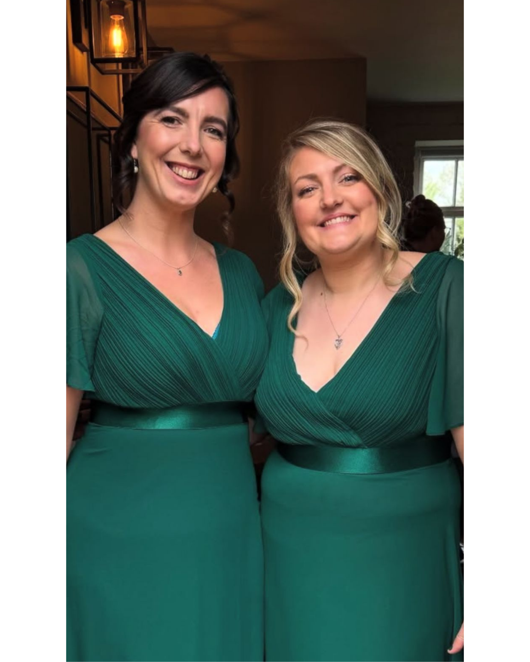 Two bridesmaids showing their bridal party makeup and updo hairstyles