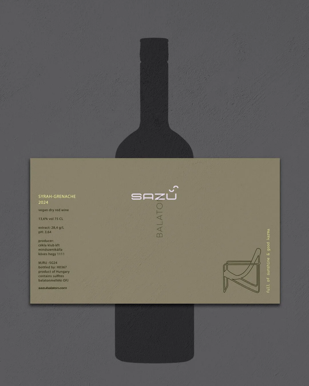 A bottle cast shadow behind a beige wine label on a gray surface.