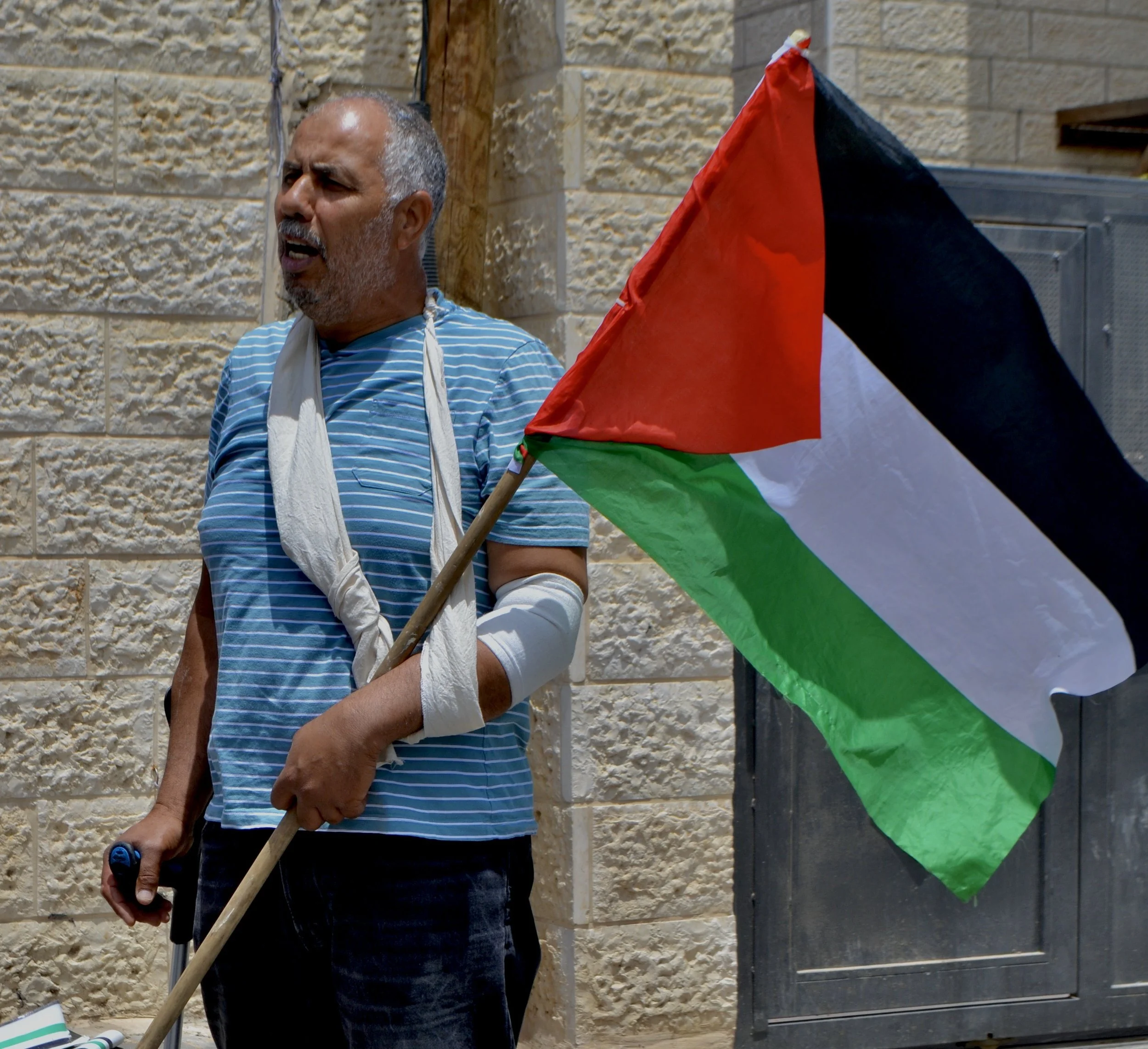 Sheikh Jarrah, May 2022.  Abu Hummus, well-known Palestinian activist, after reportedly being injured by militants in a protest. 