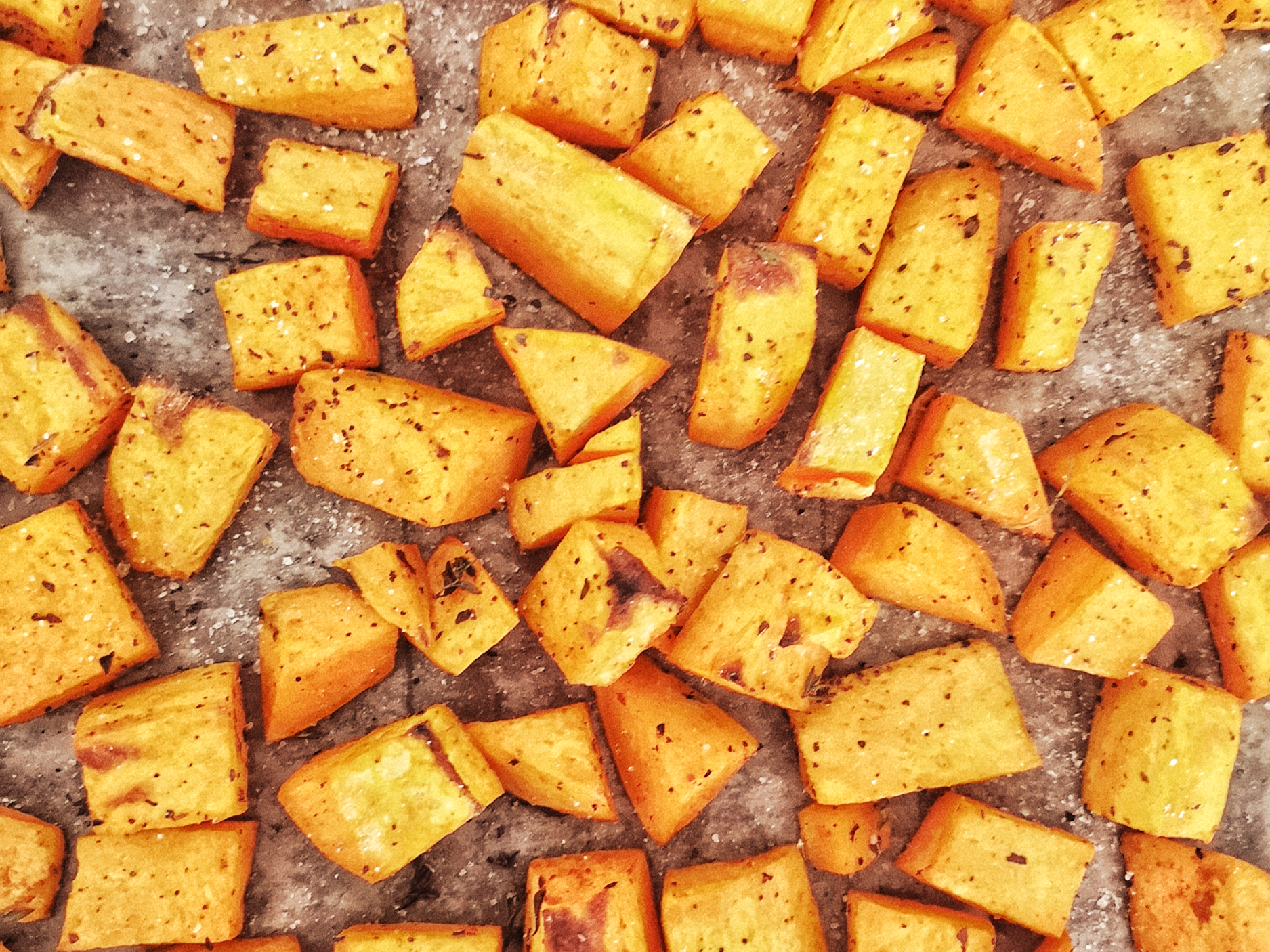 Cubed baked sweet potatoes on sheet pan