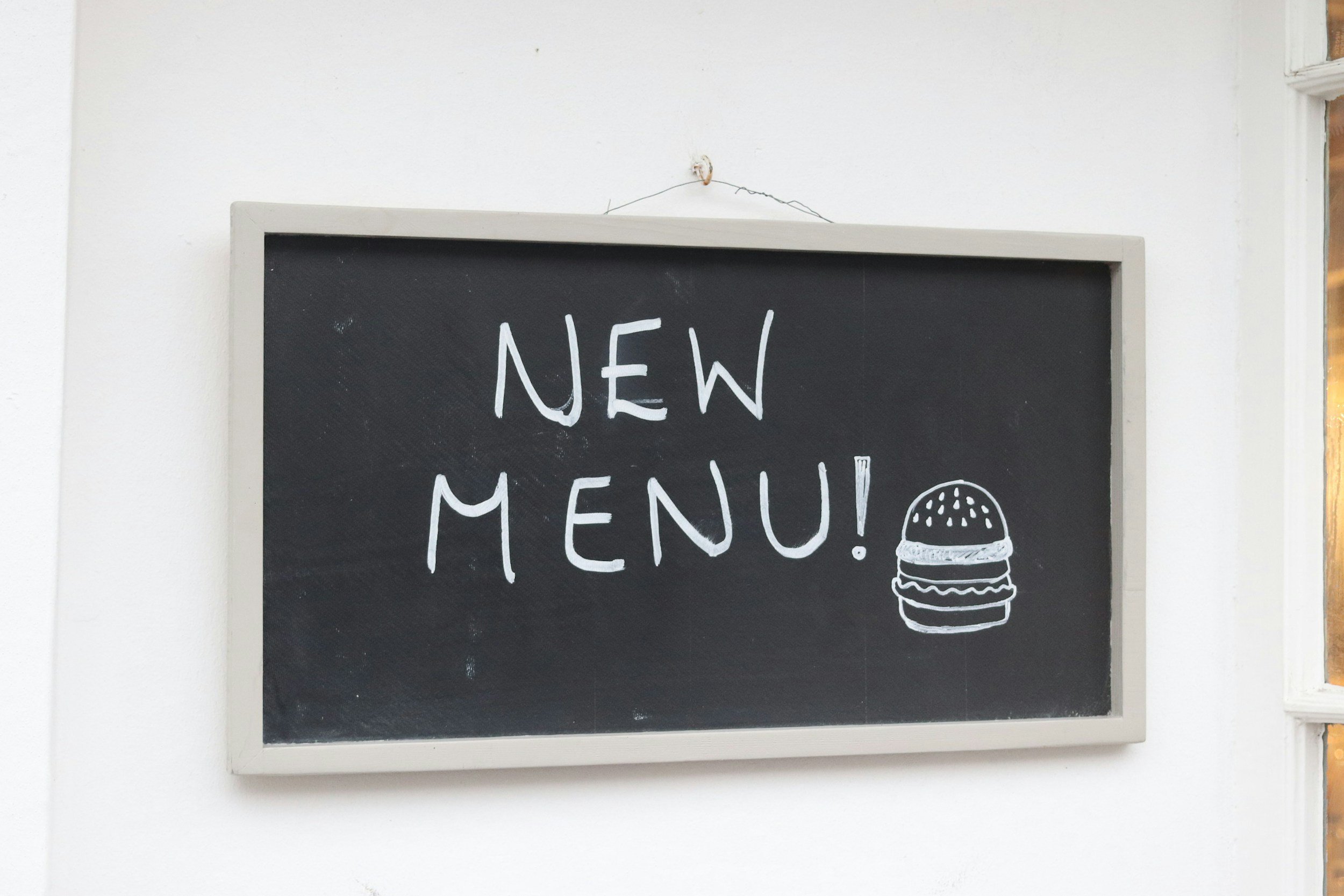Chalkboard sign advertising a new brunch menu outside a restaurant