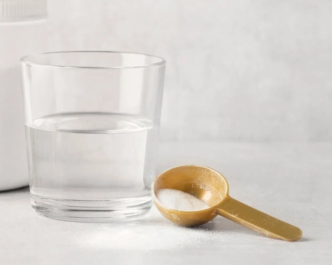 Glass of water with electrolyte powder being stirred in
