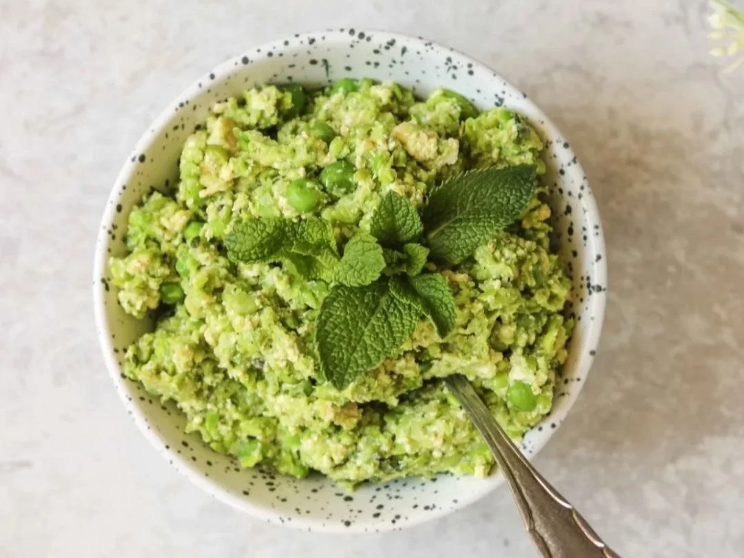 A bowl of green tofu and pea paste with fresh mint