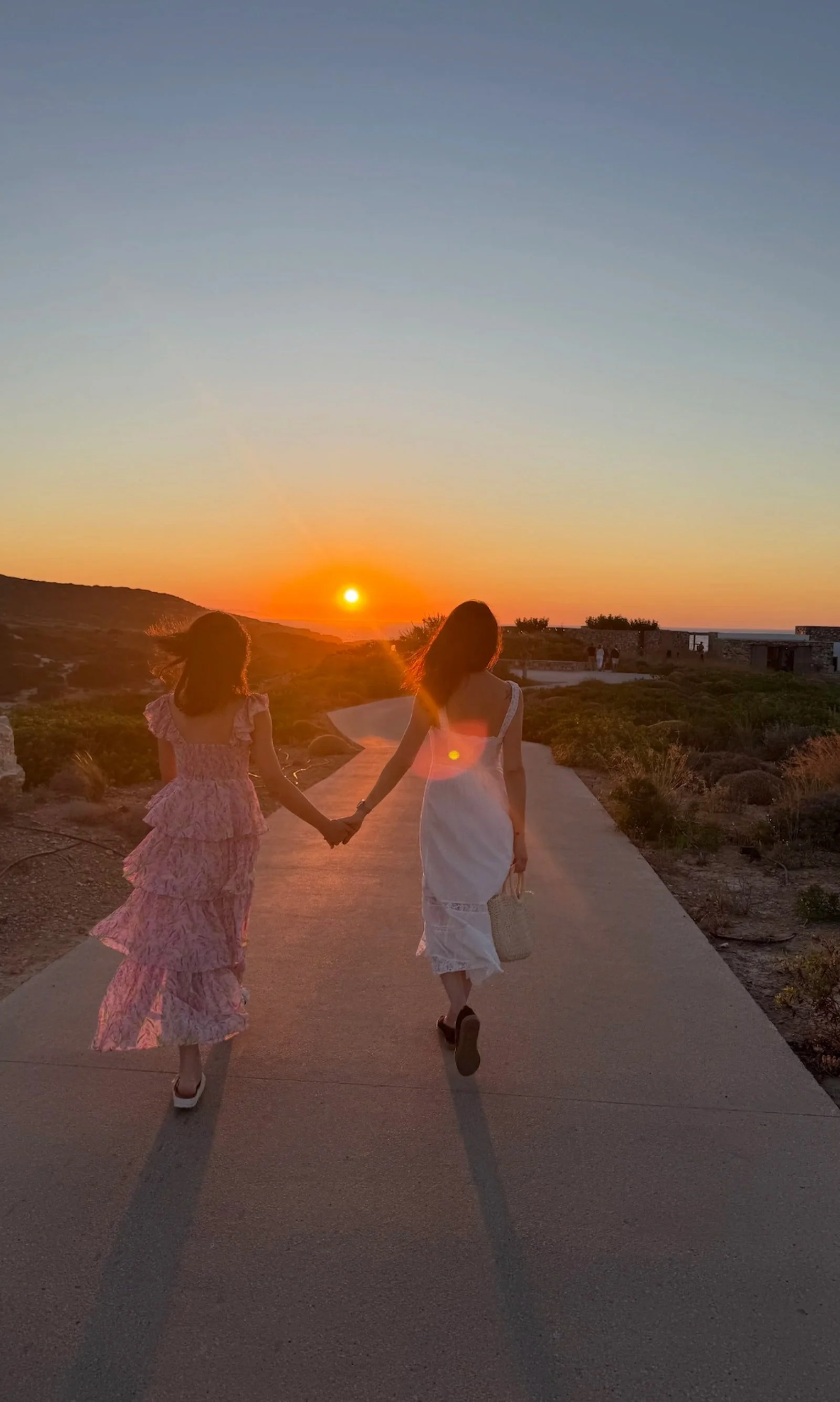 Coco Pierrel walking toward the sunset with her daughter