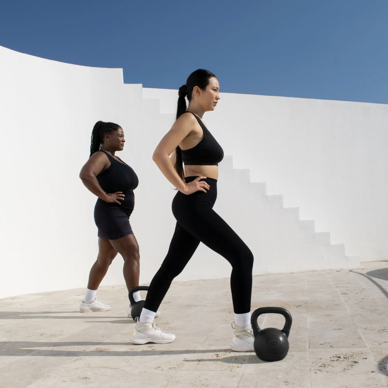 A woman over 40 lifting weights to build muscle and support weight loss through strength training.