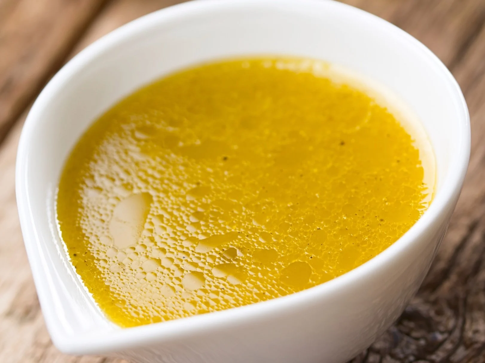 A jar of vinaigrette with olive oil, red wine vinegar and Dijon mustard