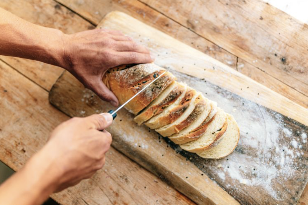 Sliced white bread on a wooden board — what happens to your blood sugar when you eat white bread every day