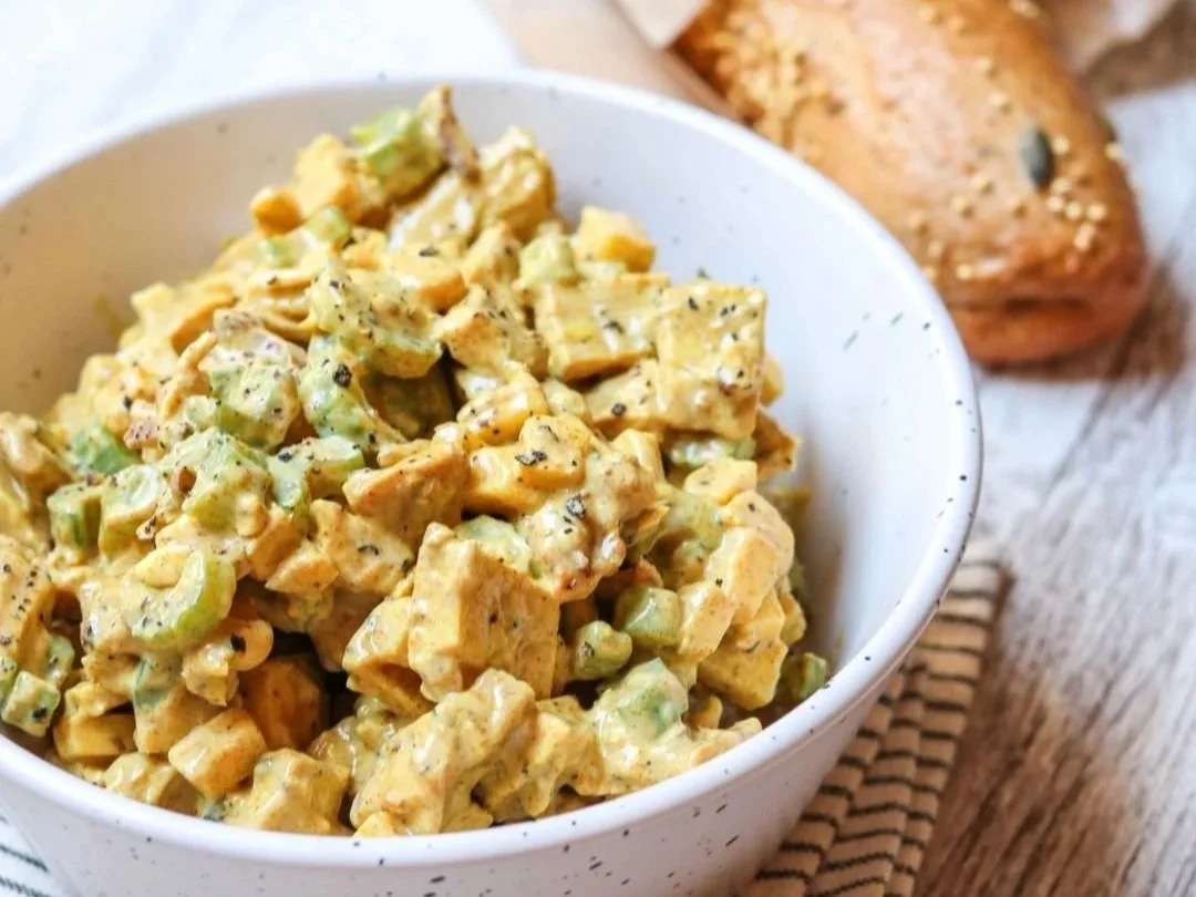 Curried chicken salad with celery and a loaf of bread