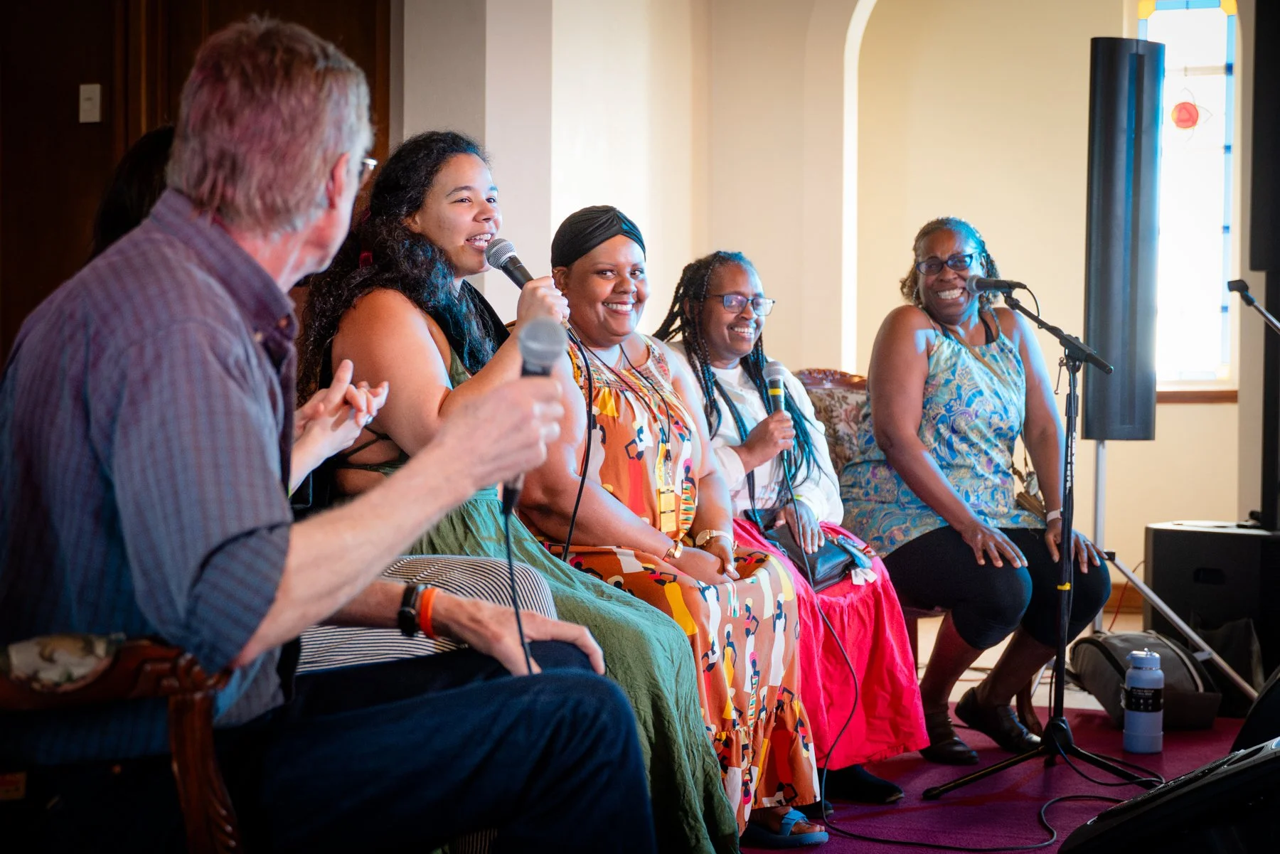 FWAAMFest's African American Dance Caller Pathways pilot cohort and instructors in conversation during a festival panel. From left right: Phil Jamison, Becky Hill, Briar, Audra Scott, Carol July, Dr. Clover Johnson. Photo by Jessica Waffles.