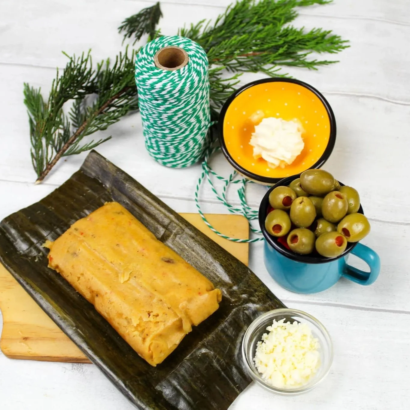 Venezuelan Bollito navideño shown with cheese, olives, nata and string