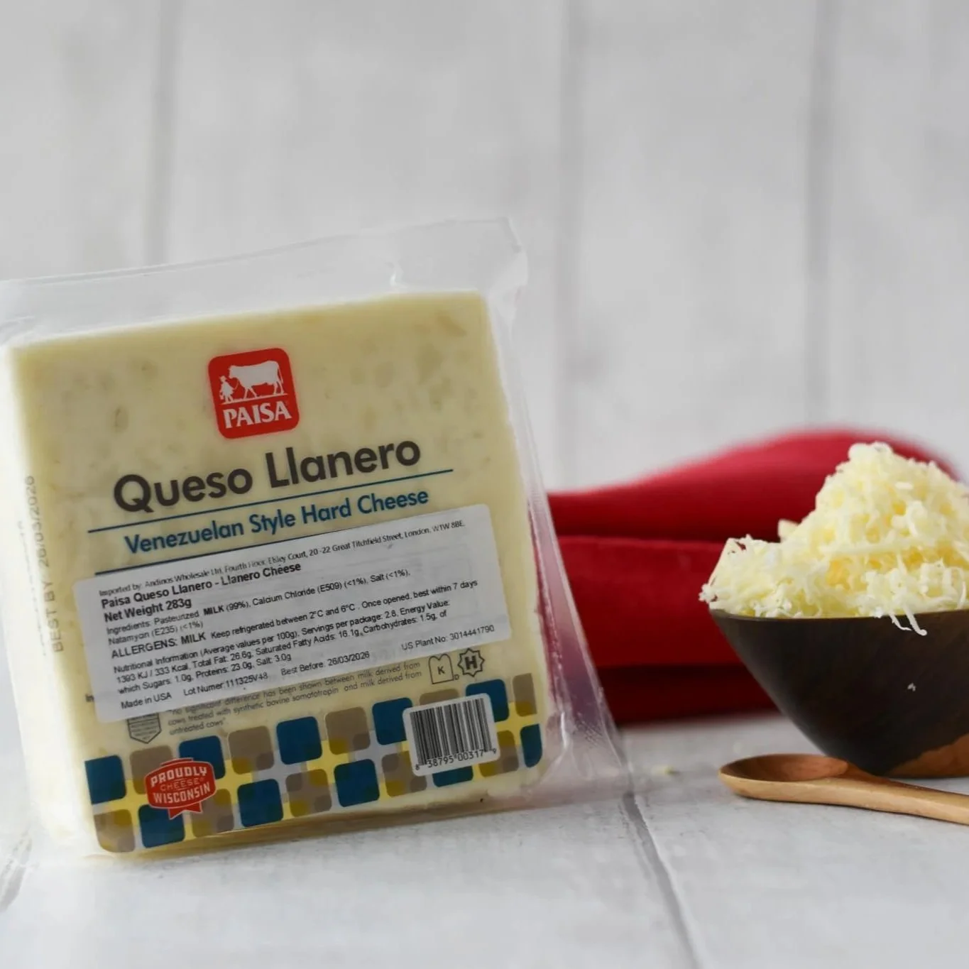 Venezuelan White cheese in packaging with wooden bowl with grated cheese in it