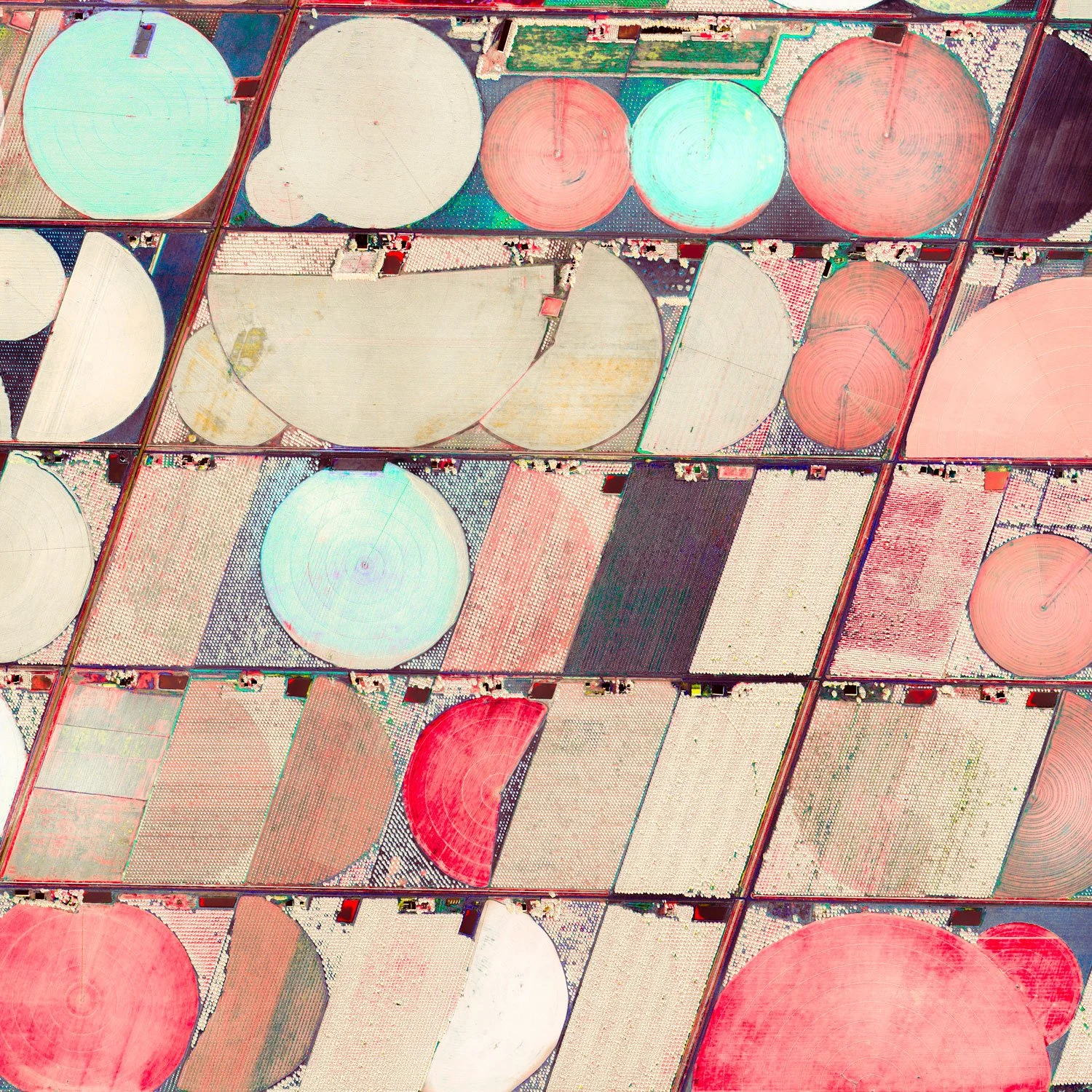 Detail of Ultradistancia Hartswater by Federico Winer showing circular irrigation fields, geometric agricultural parcels, and soft pastel colors with vivid red accents seen from above.