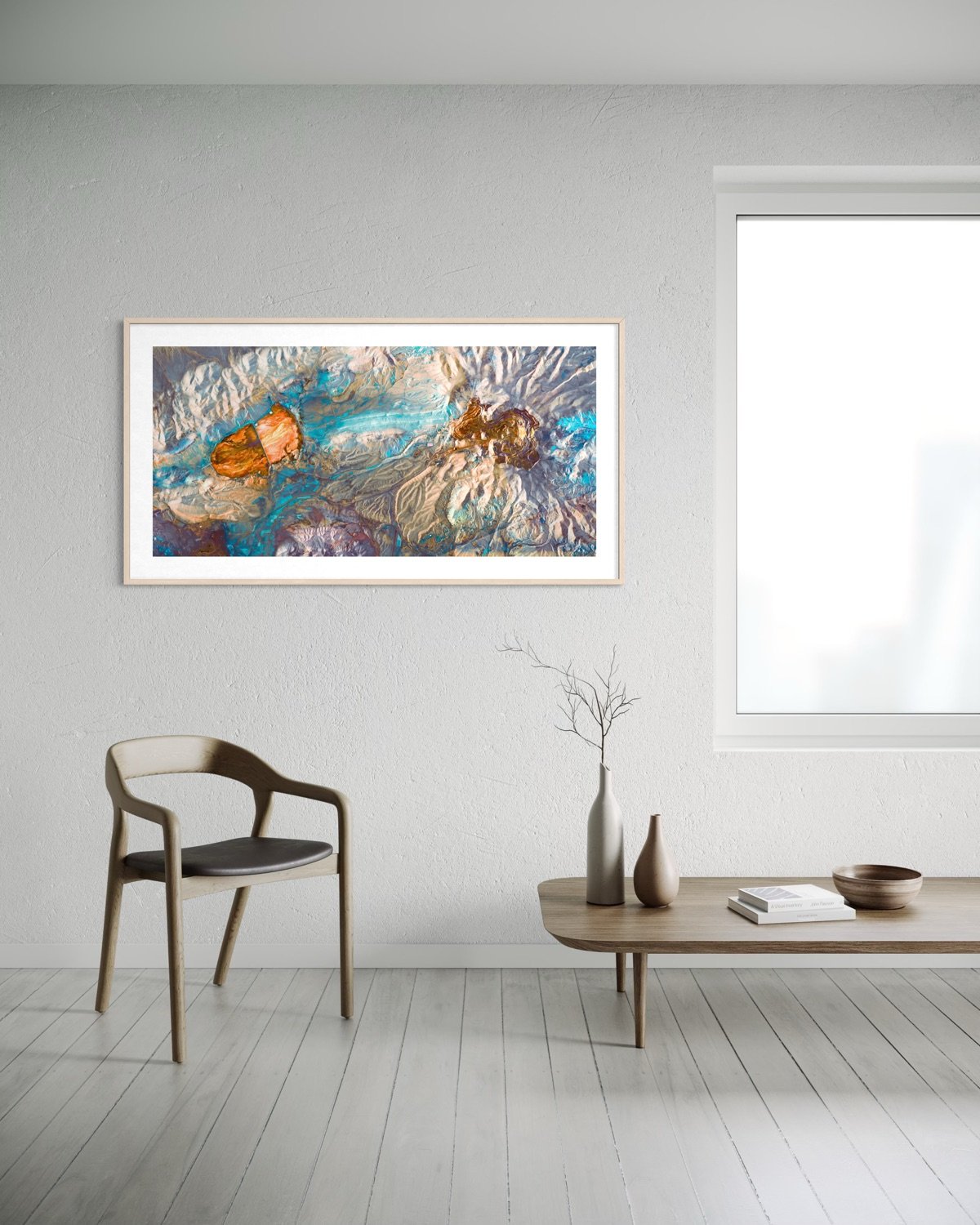 A modern minimalist room with a gray wall, a colorful abstract painting, a wooden chair with a black cushion, a wooden table with vases and books, and a window letting in natural light.
