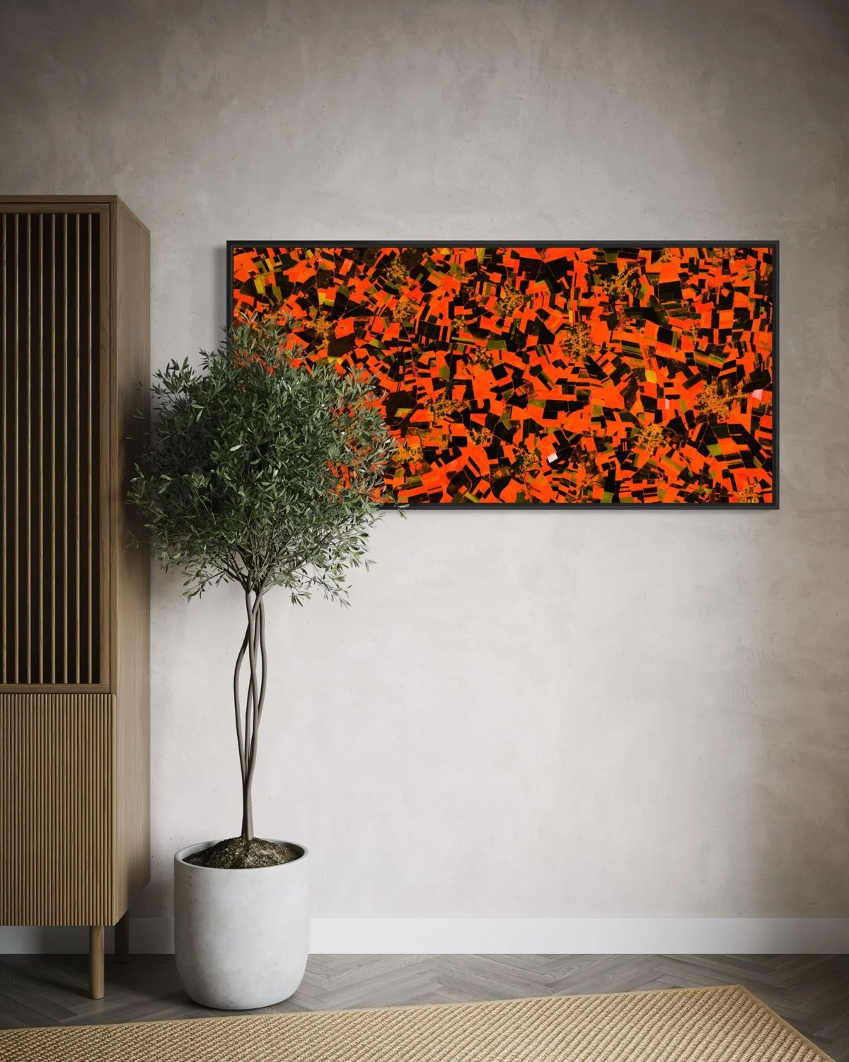 Ultradistancia Pas de Calais by Federico Winer installed above a curved sofa in a contemporary interior, showing a panoramic satellite artwork with vivid red and dark agricultural patterns.