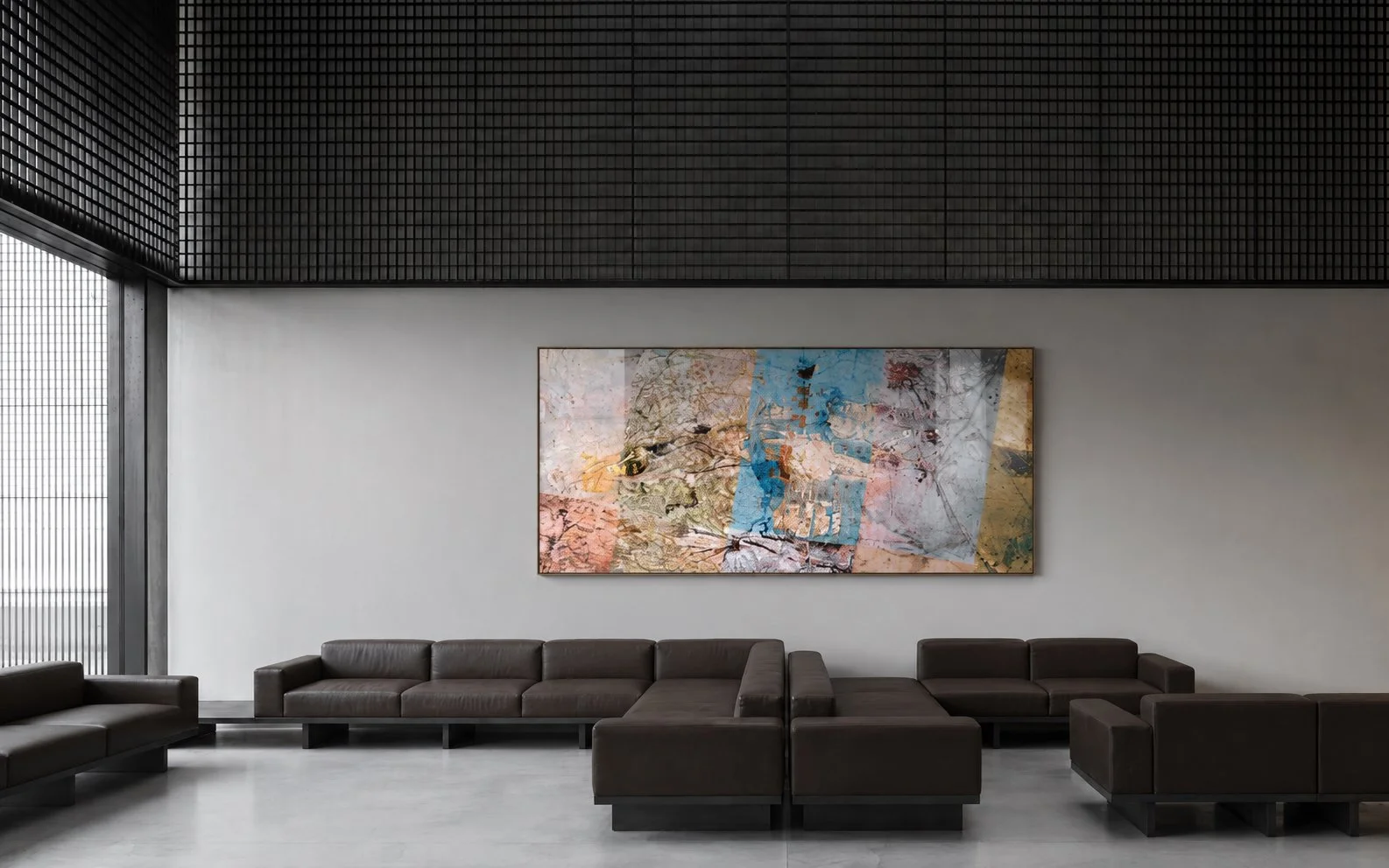 Modern lobby with dark brown leather sofas, abstract colorful painting on a white wall, large window with small grid pattern, black ceiling with textured panels.