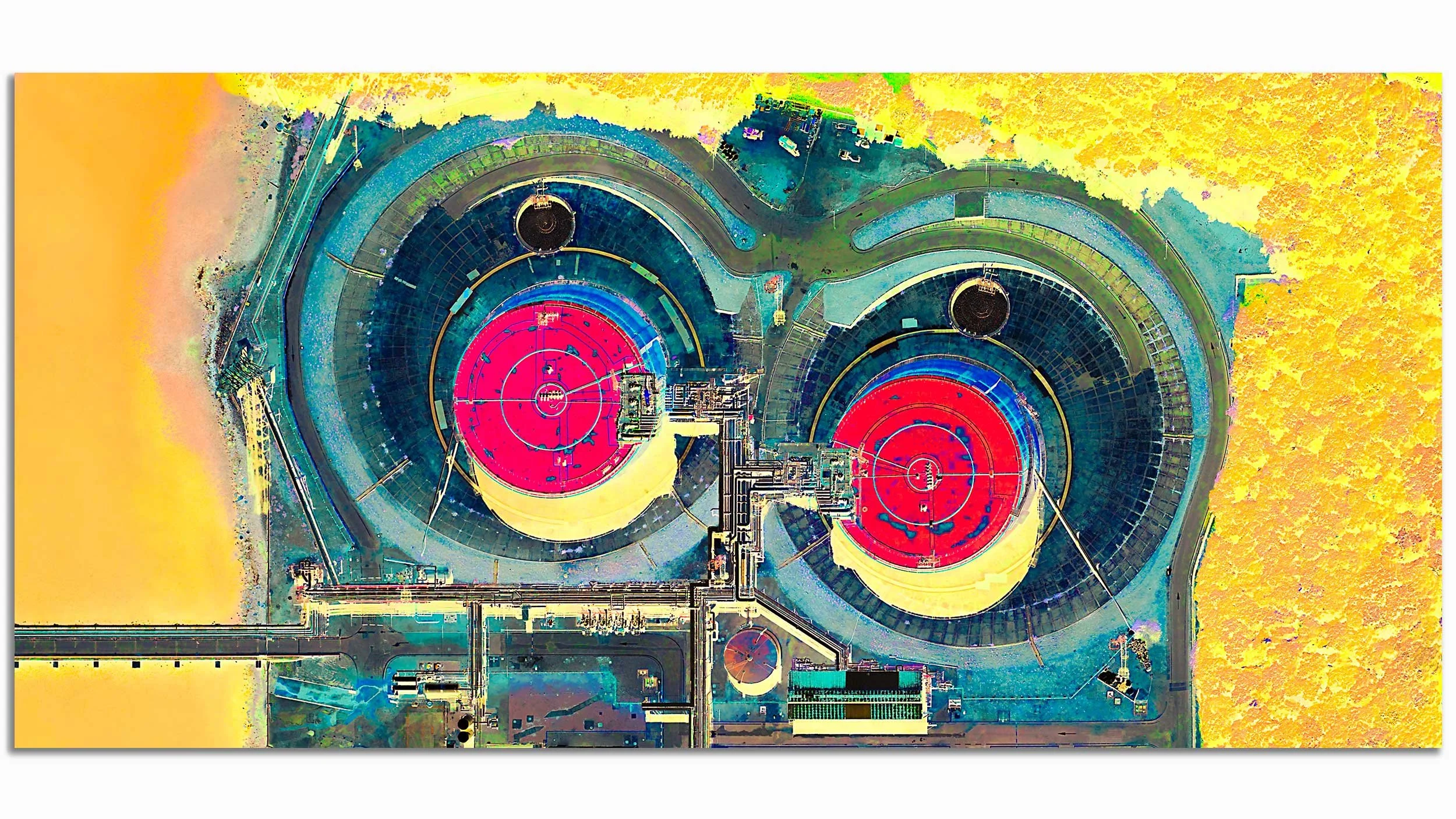 An aerial view of a construction site with large circular structures, some with red surfaces, surrounded by various construction equipment and roads, and yellow terrain around the site.