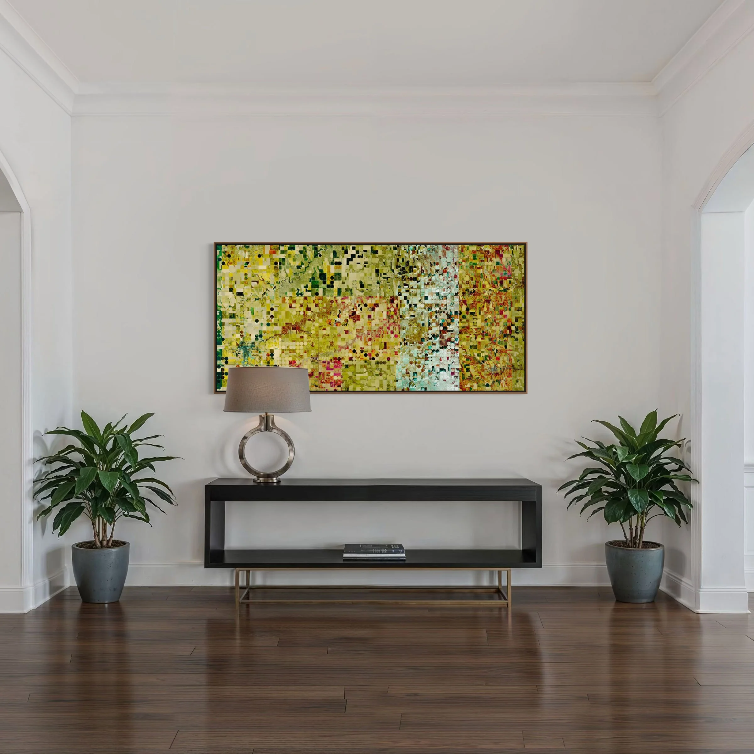 Framed panoramic satellite artwork of agricultural fields in Colby, Kansas, USA, from Federico Winer’s Ultradistancia Fields Series, displayed in a contemporary interior above a black console table between two potted plants.