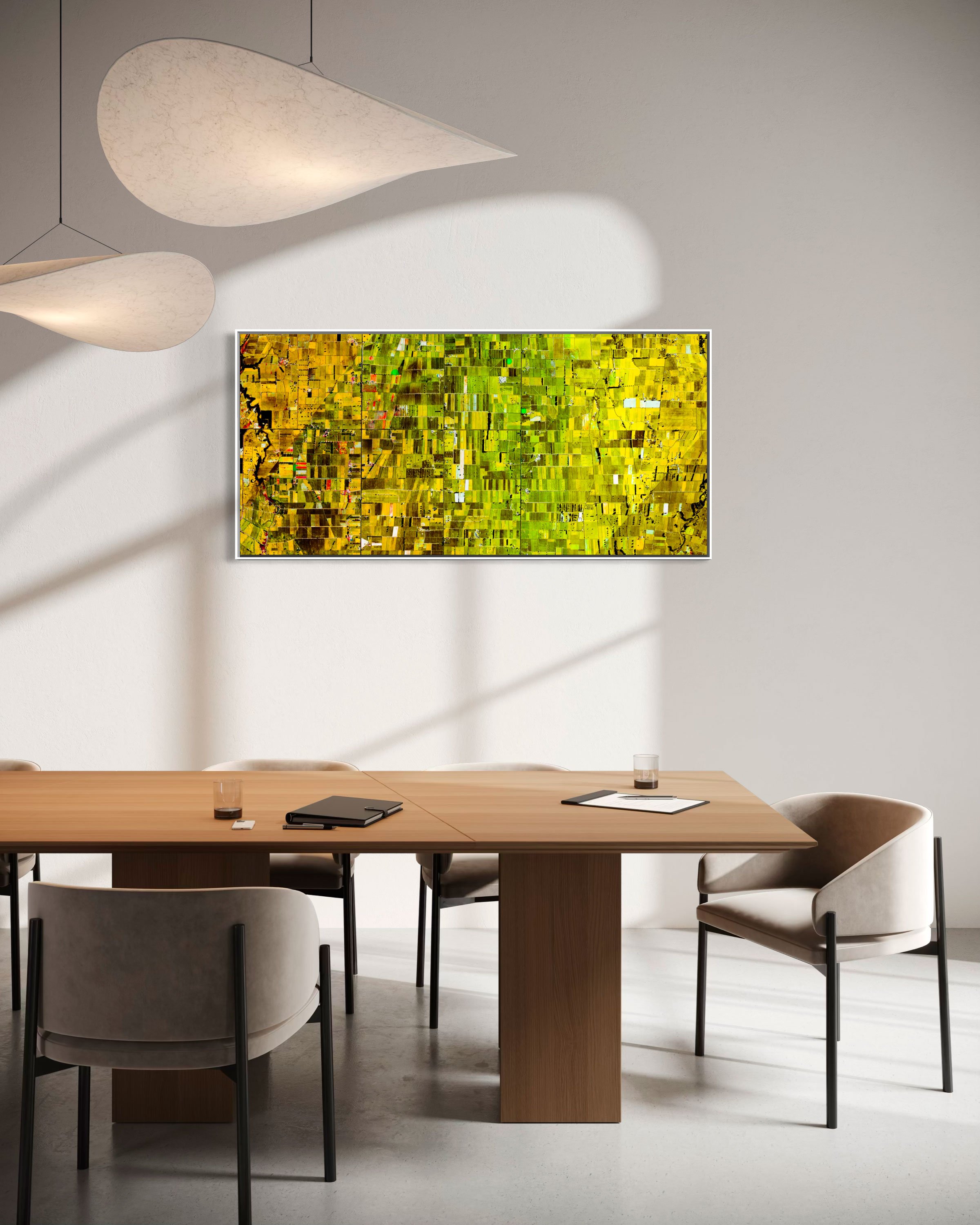 Ultradistancia Morrinsville by Federico Winer installed in a contemporary dining room, showing a panoramic satellite artwork of agricultural fields in soft pastel tones and geometric circular patterns.