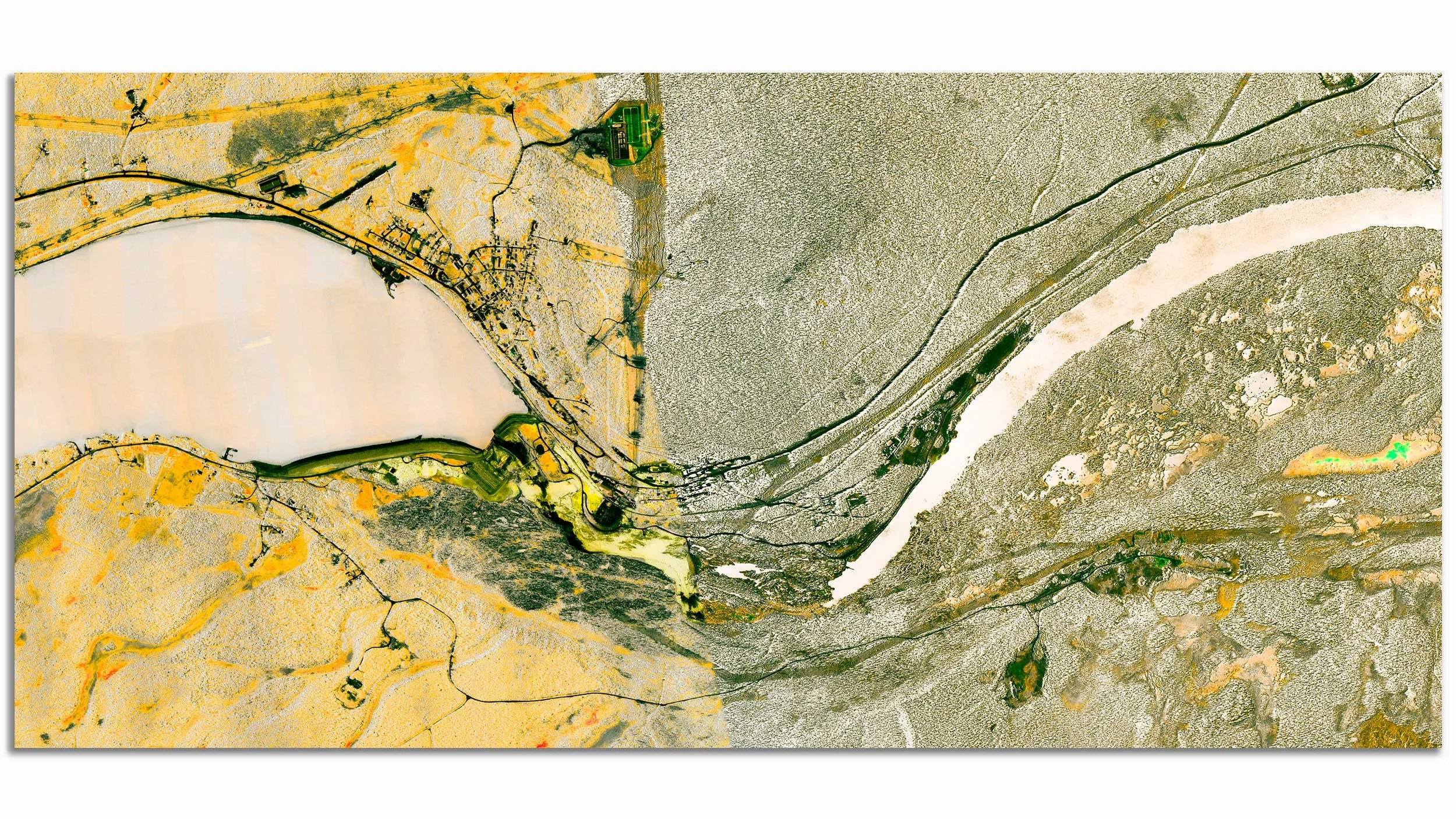 A satellite view of a river winding through a landscape with contrasting terrain and vegetation.
