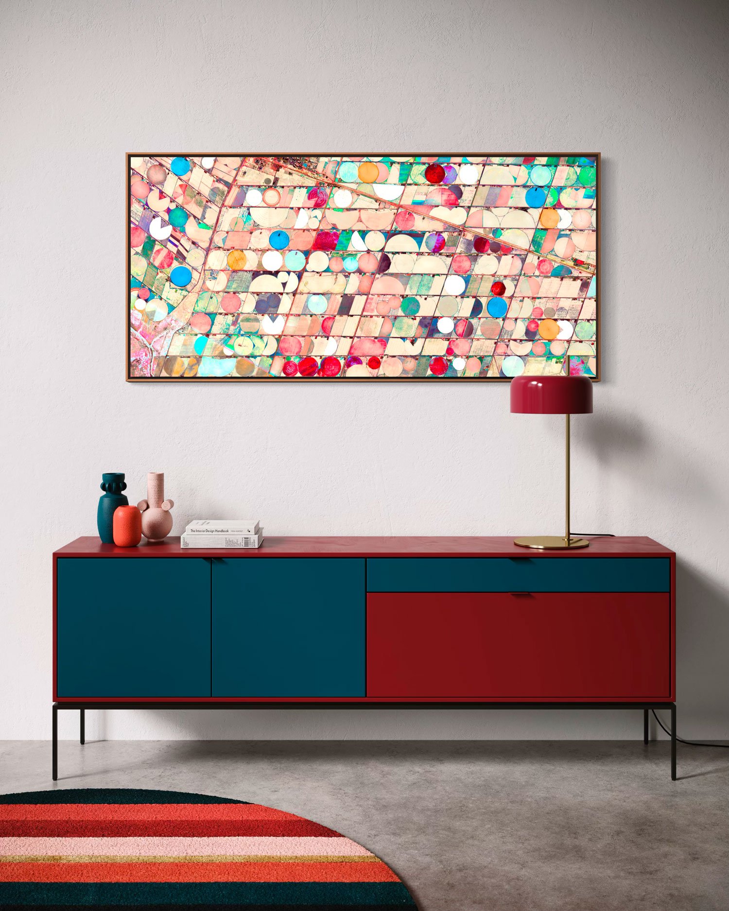 Ultradistancia Hartswater by Federico Winer installed above a contemporary sideboard, showing a panoramic satellite artwork of circular irrigation fields in soft pink, turquoise, cream, and red tones.