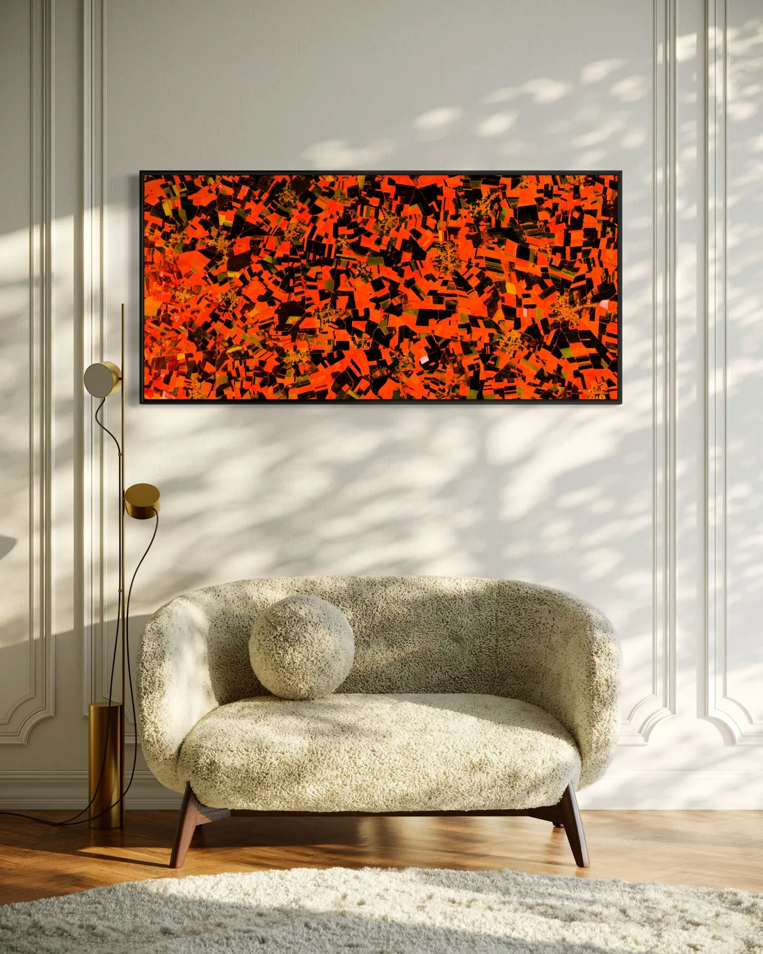 Interior view of Pas de Calais by Federico Winer installed above a curved sofa, showing a panoramic satellite artwork with vivid orange-red agricultural patterns.