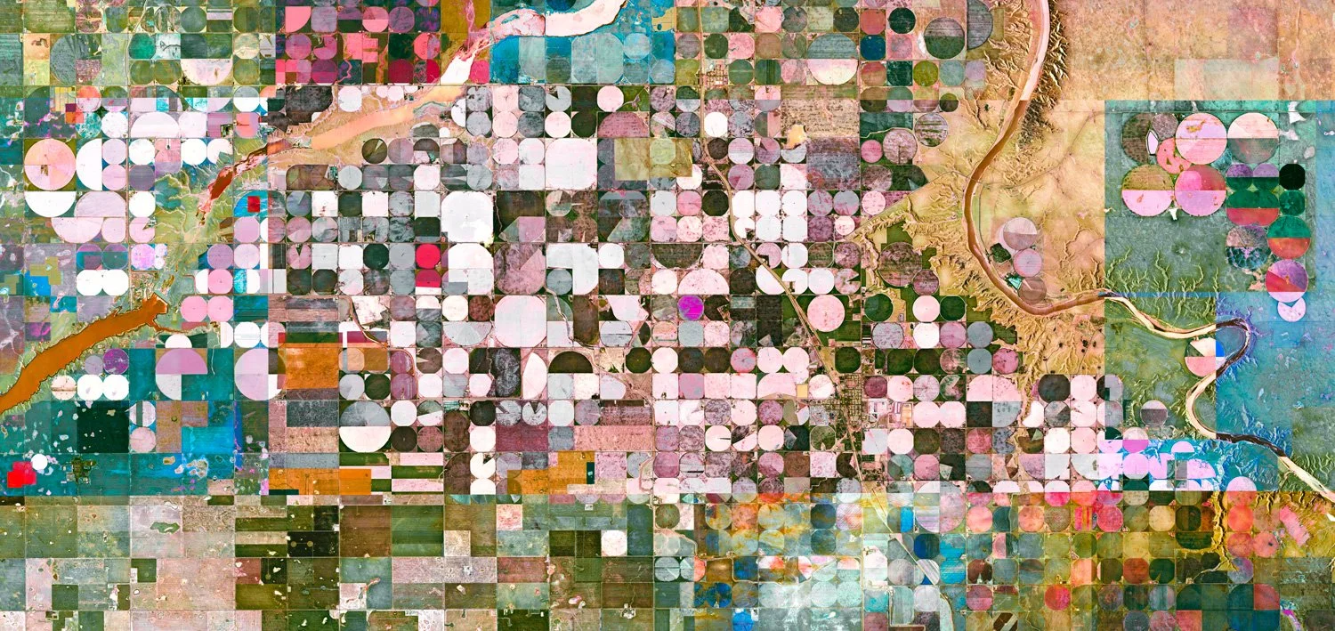 A colorful satellite image of farmland showing various geometric fields in different colors and shapes.