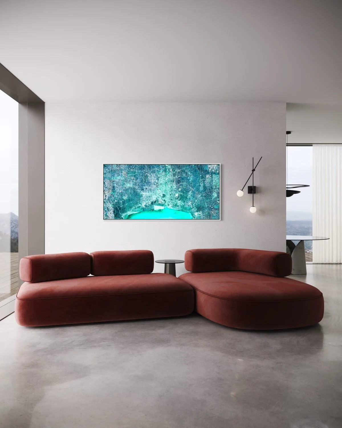 Modern living room with a red velvet sectional sofa, a small black side table, a wall-mounted flat-screen TV, and a contemporary wall sconce with two white globe bulbs, large windows with scenic mountain views.