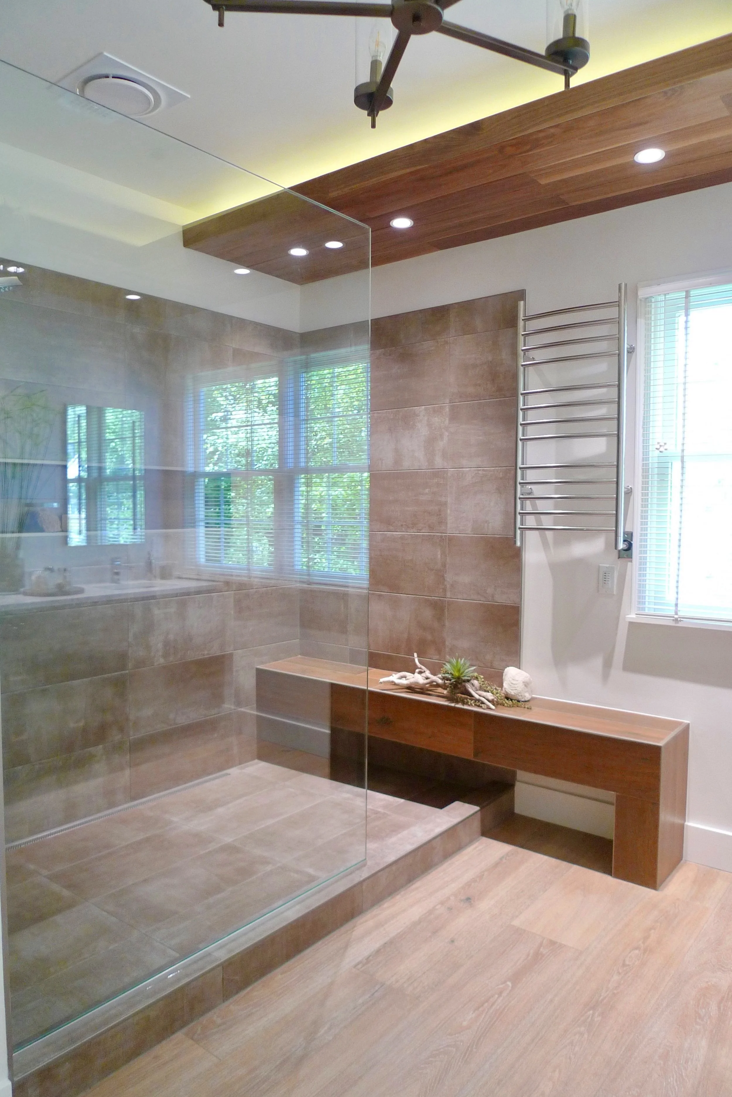 Master bath designed with a spacious shower and bench