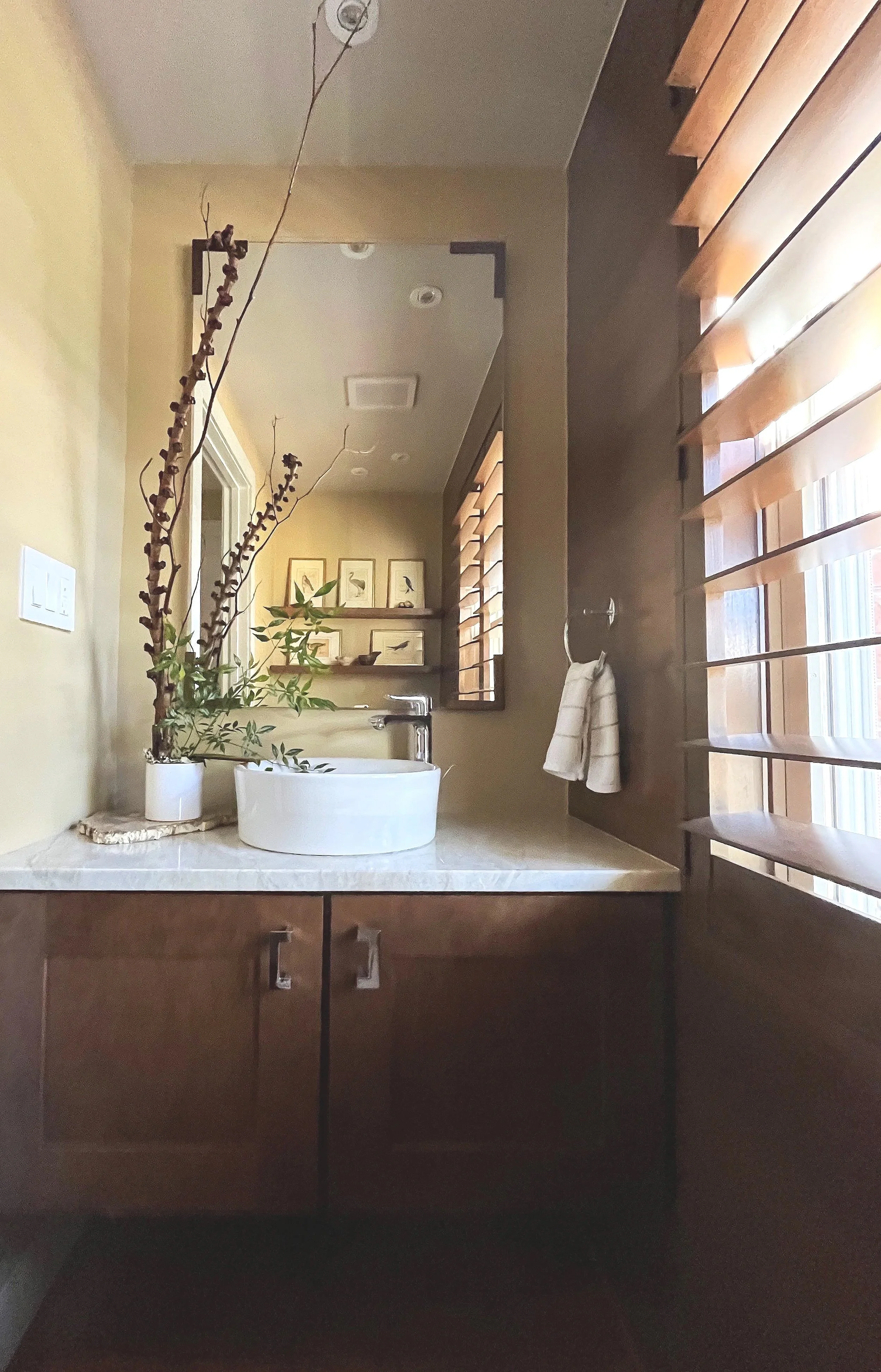 Wall mounted cabinet allows for storage without taking up square footage