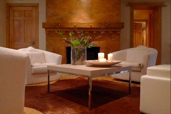 Full renovation of this basement includes, transforming the brick chimney into plaster and glaze with a custom mantel