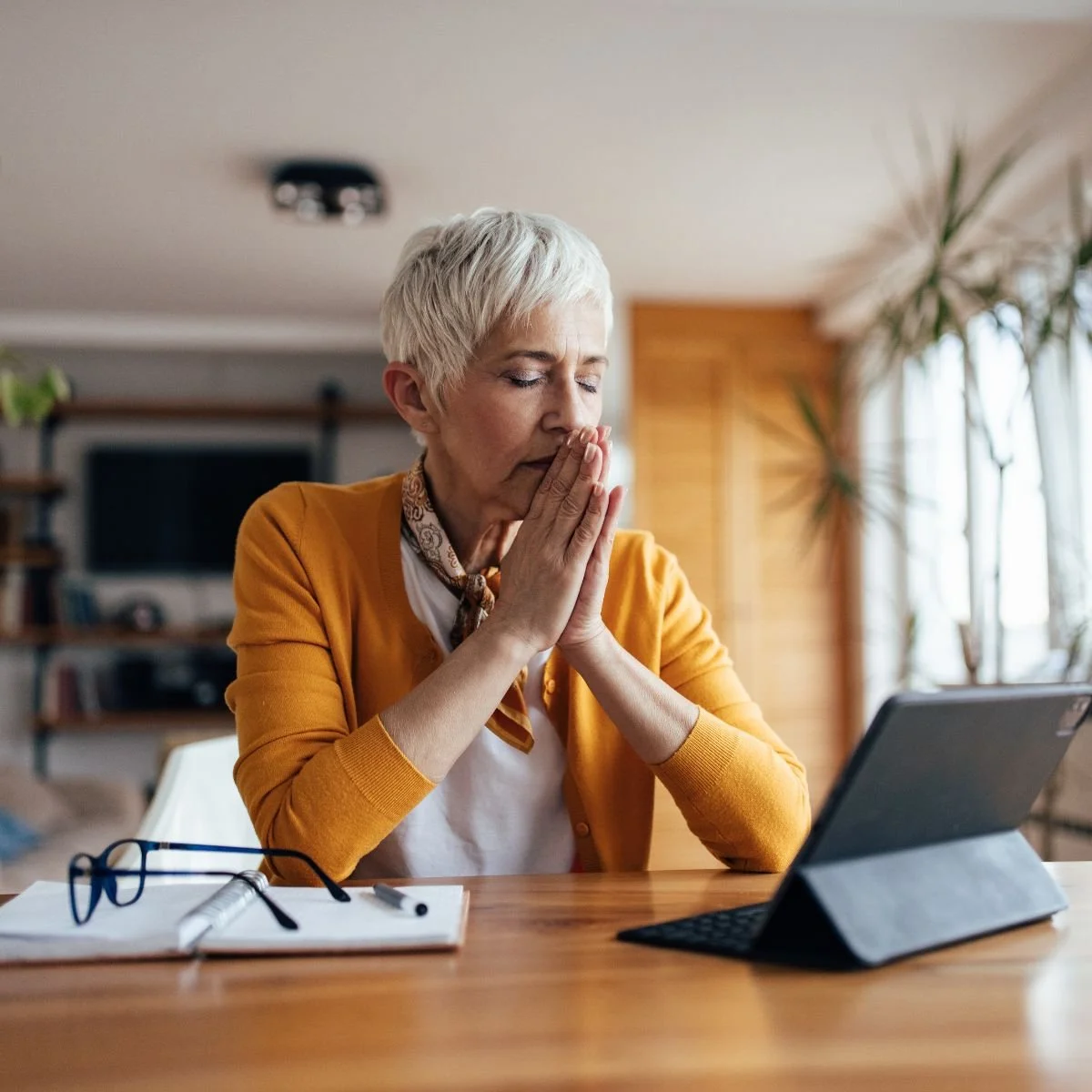 Middle aged woman at a desk practicing coping skills