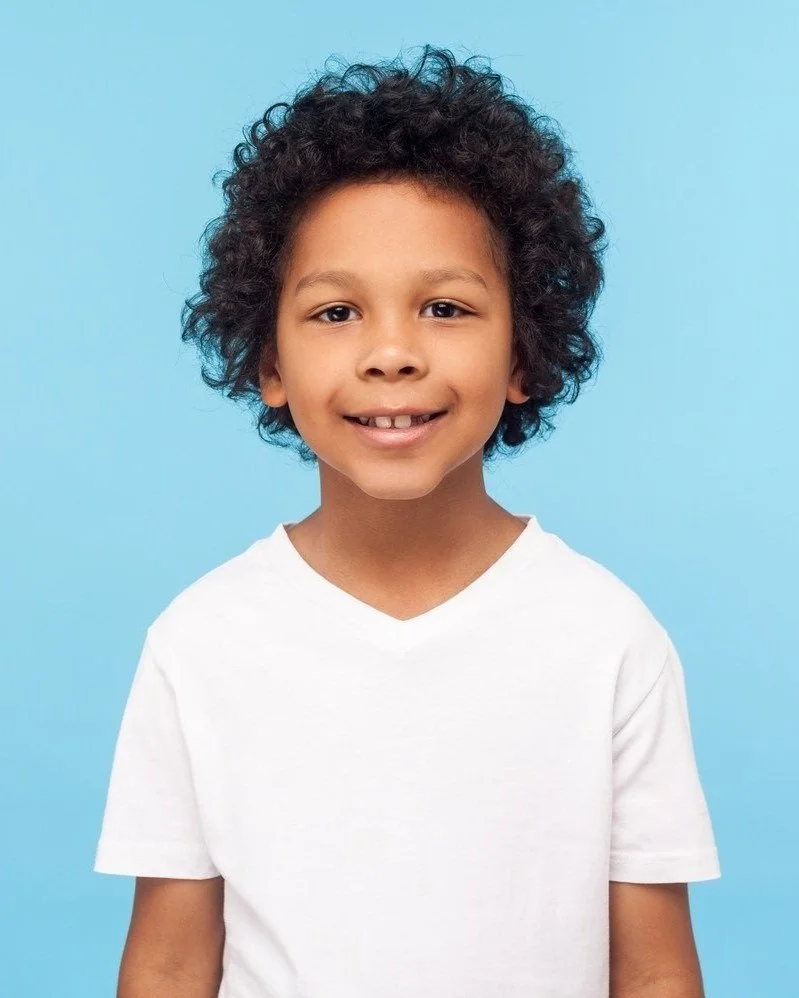 Smiling young boy with curly hair
