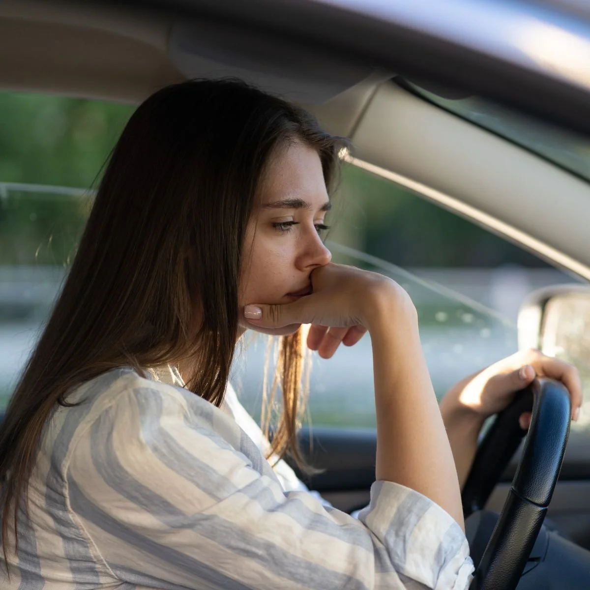 Young woman in her car sad over a breakup