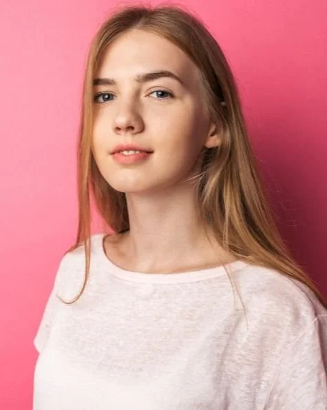 Teenage girl against a pink background
