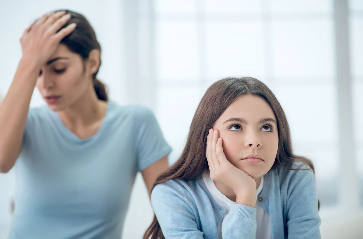 teen sitting annoyed with parent