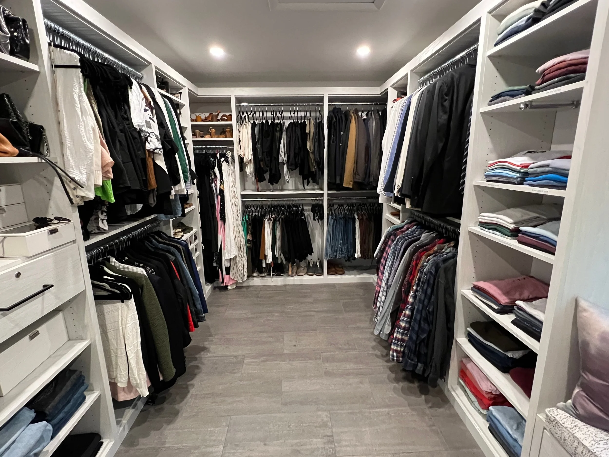 Walk-in closet with folded and hung clothing.